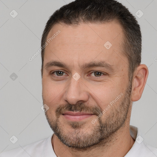 Joyful white adult male with short  brown hair and brown eyes