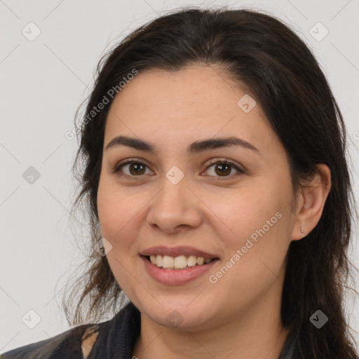 Joyful white young-adult female with long  brown hair and brown eyes