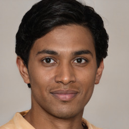 Joyful latino young-adult male with short  brown hair and brown eyes