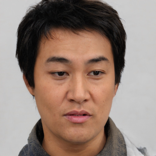 Neutral asian young-adult male with short  brown hair and brown eyes