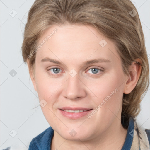 Joyful white young-adult female with medium  brown hair and blue eyes