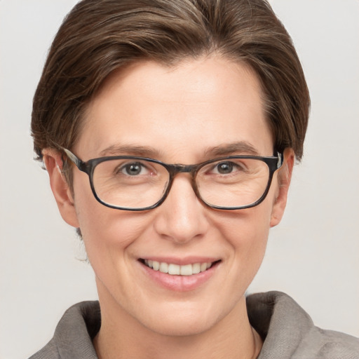 Joyful white adult female with short  brown hair and grey eyes