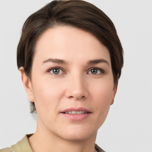 Joyful white young-adult female with short  brown hair and grey eyes