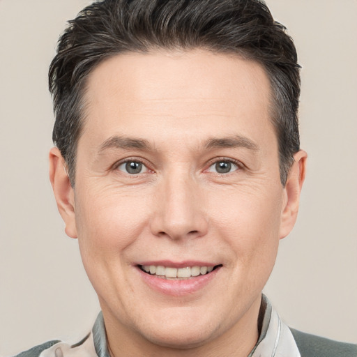 Joyful white adult male with short  brown hair and brown eyes