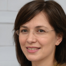 Joyful white adult female with long  brown hair and brown eyes