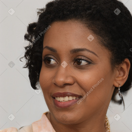 Joyful black young-adult female with short  brown hair and brown eyes