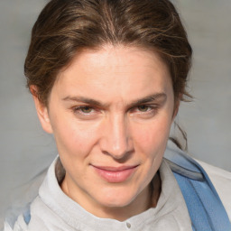 Joyful white adult female with medium  brown hair and blue eyes