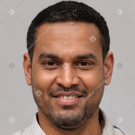 Joyful latino adult male with short  black hair and brown eyes