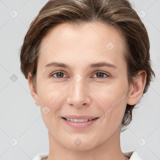 Joyful white young-adult female with medium  brown hair and grey eyes