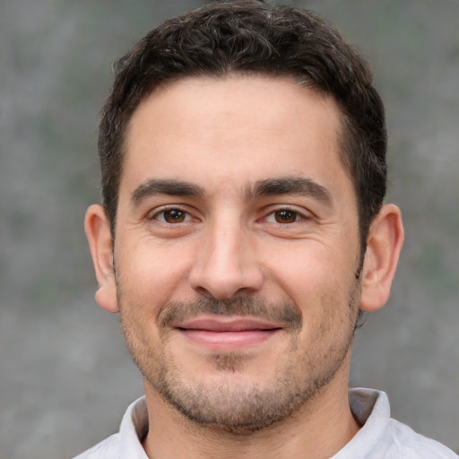 Joyful white adult male with short  brown hair and brown eyes