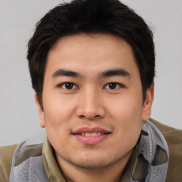 Joyful asian young-adult male with short  brown hair and brown eyes