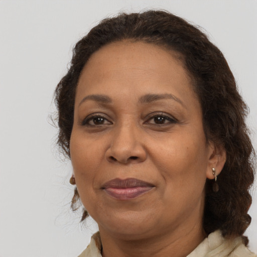 Joyful latino adult female with medium  brown hair and brown eyes
