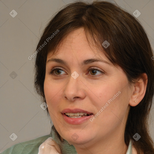 Joyful white adult female with medium  brown hair and brown eyes