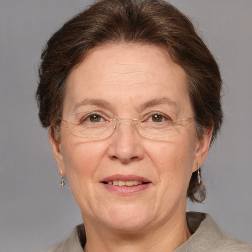 Joyful white middle-aged female with medium  brown hair and grey eyes