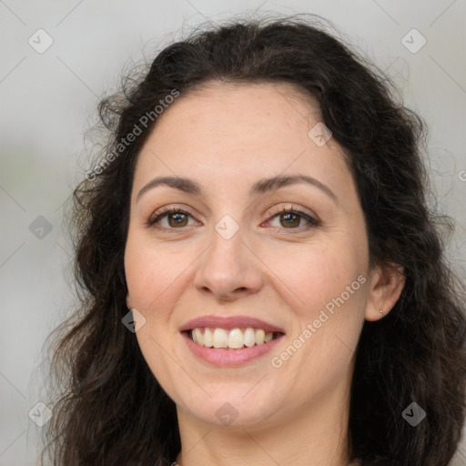 Joyful white adult female with long  brown hair and brown eyes