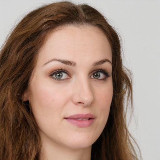 Joyful white young-adult female with long  brown hair and green eyes