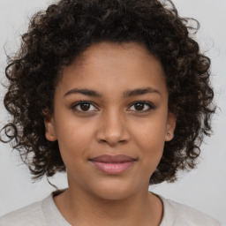 Joyful black young-adult female with medium  brown hair and brown eyes