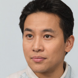 Joyful asian young-adult male with short  brown hair and brown eyes