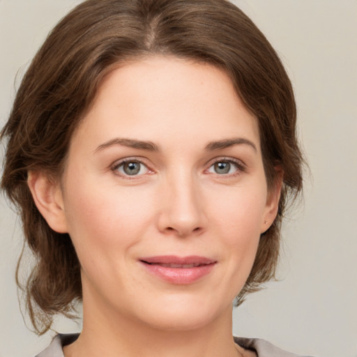 Joyful white young-adult female with medium  brown hair and green eyes