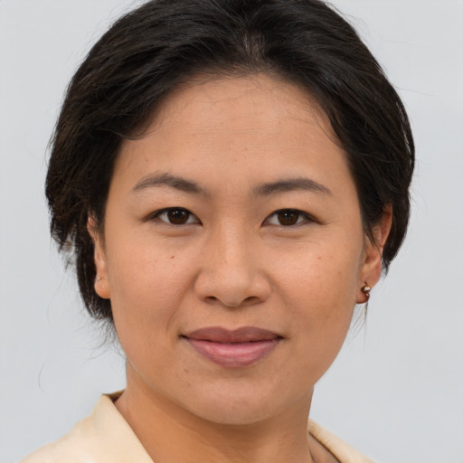Joyful asian young-adult female with short  brown hair and brown eyes