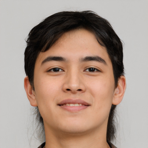 Joyful asian young-adult male with short  brown hair and brown eyes