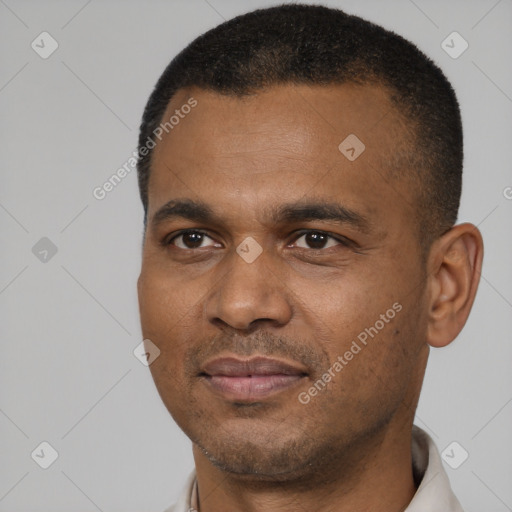 Joyful black young-adult male with short  black hair and brown eyes