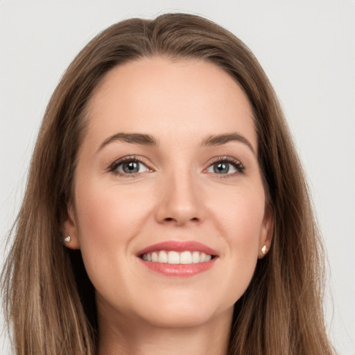 Joyful white young-adult female with long  brown hair and grey eyes