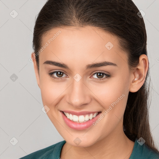 Joyful white young-adult female with long  brown hair and brown eyes