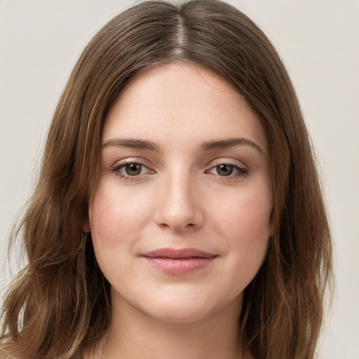 Joyful white young-adult female with long  brown hair and green eyes