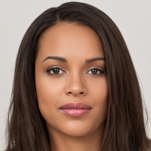 Joyful latino young-adult female with long  brown hair and brown eyes