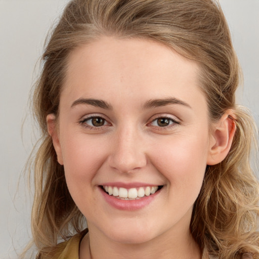 Joyful white young-adult female with long  brown hair and grey eyes