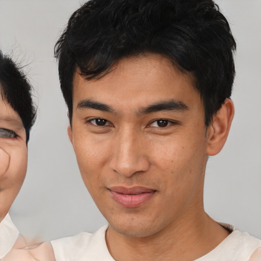 Joyful asian young-adult male with short  black hair and brown eyes