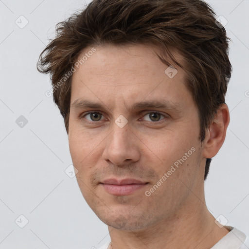 Joyful white adult male with short  brown hair and grey eyes