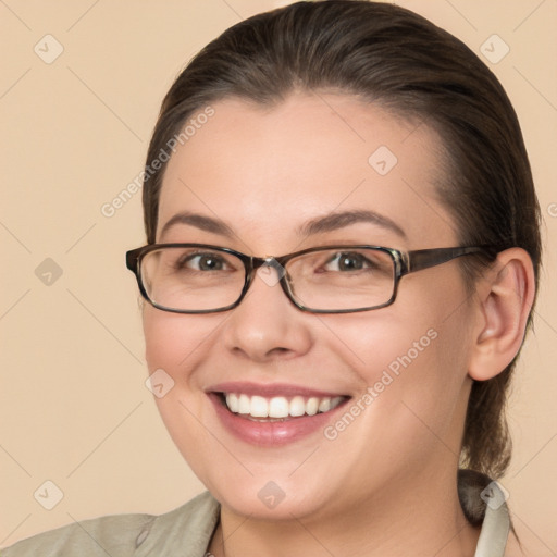 Joyful white young-adult female with medium  brown hair and grey eyes