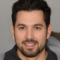 Joyful white adult male with short  brown hair and brown eyes