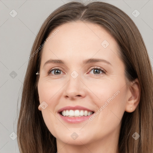 Joyful white young-adult female with long  brown hair and grey eyes