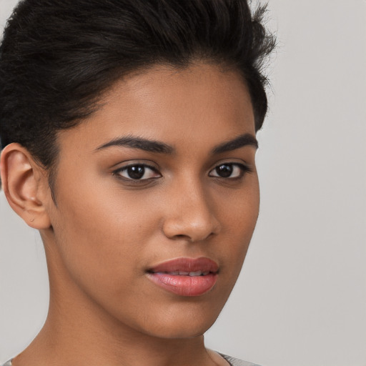 Joyful latino young-adult female with short  brown hair and brown eyes