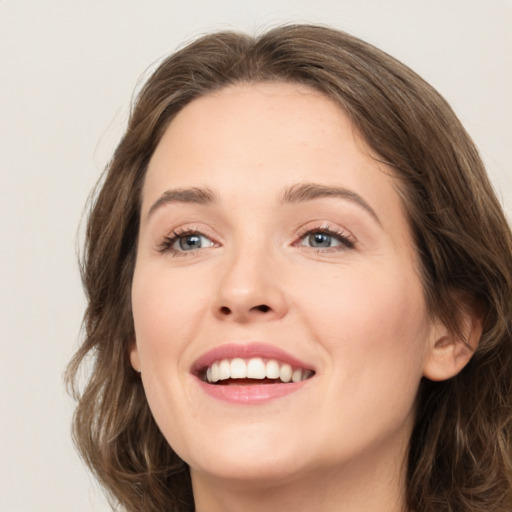 Joyful white young-adult female with medium  brown hair and green eyes