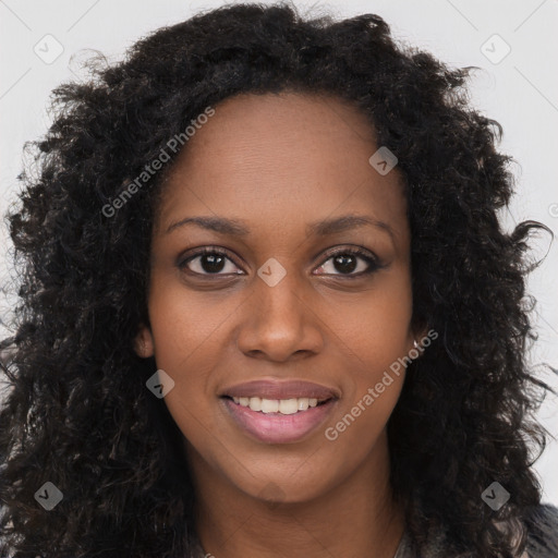 Joyful black young-adult female with long  brown hair and brown eyes