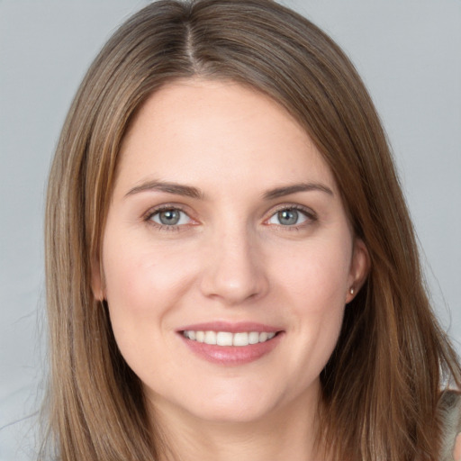 Joyful white young-adult female with long  brown hair and grey eyes