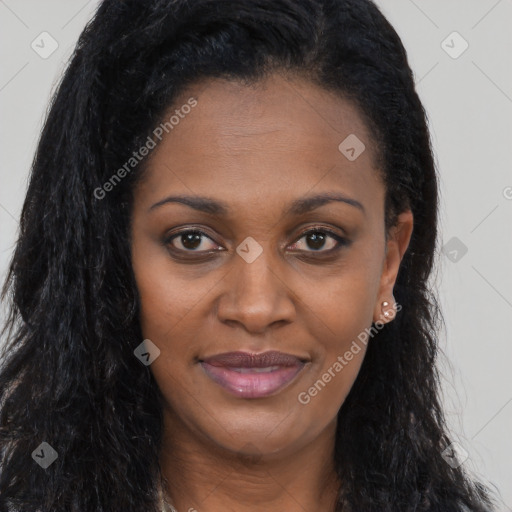 Joyful black young-adult female with long  brown hair and brown eyes