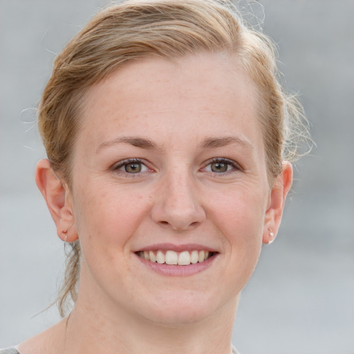 Joyful white adult female with medium  brown hair and blue eyes