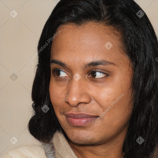 Joyful latino young-adult female with long  brown hair and brown eyes