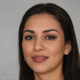 Joyful latino young-adult female with long  brown hair and brown eyes