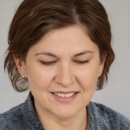 Joyful white adult female with medium  brown hair and brown eyes