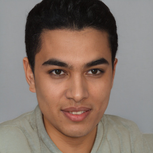 Joyful latino young-adult male with short  black hair and brown eyes