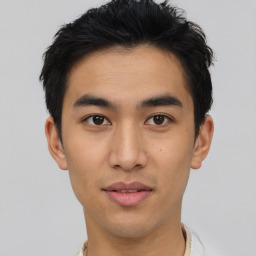 Joyful asian young-adult male with short  brown hair and brown eyes