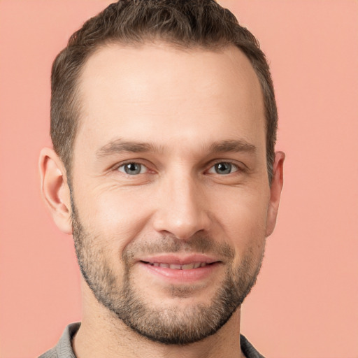 Joyful white young-adult male with short  brown hair and brown eyes