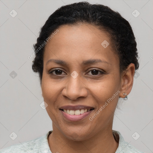 Joyful latino young-adult female with short  brown hair and brown eyes