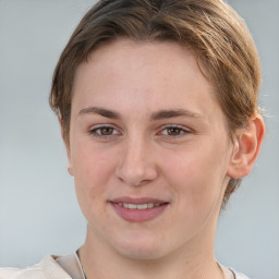 Joyful white young-adult female with short  brown hair and grey eyes